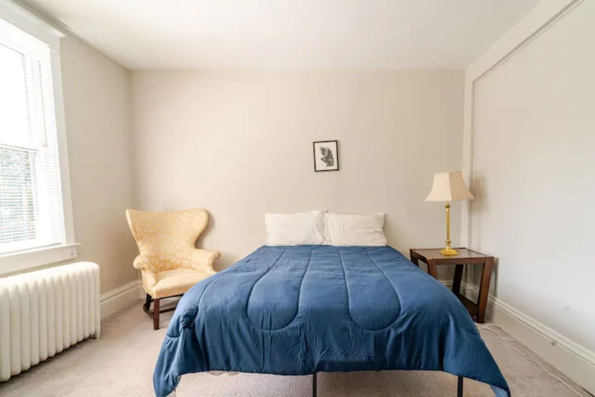 สถานที่พักผ่อนในห้องนอน: ที่พักสว่างและโปร่งสบายพร้อมเตียงนอนสบายและเก้าอี้เน้นเสียงที่มีเสน่ห์!