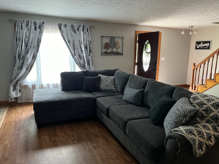 A view of the downstairs open area that contains its own studio apartment with separate kitchen and appliances.  This is facing the front door to the home and the staircase upstairs, which can be separated and two families and privately cohabitate.