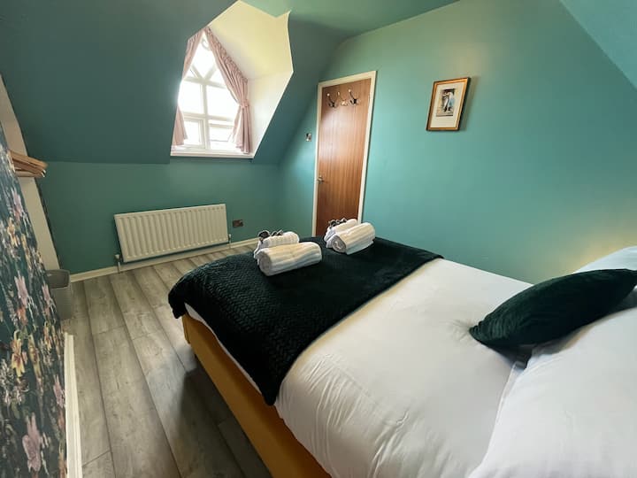 The largest bedroom in the cottage with a stunning window and incredible views.  The bed sleeps 2 and is made up with luxury Dorma bedding and fluffy throws. Blackout curtains and multi level touch lamps ensure a good nights rest. 