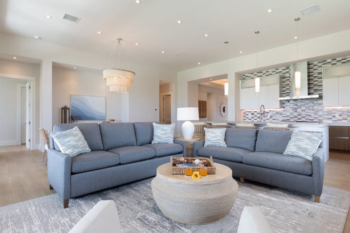 Comfy seating with 85" TV in large living room with 12 foot ceilings