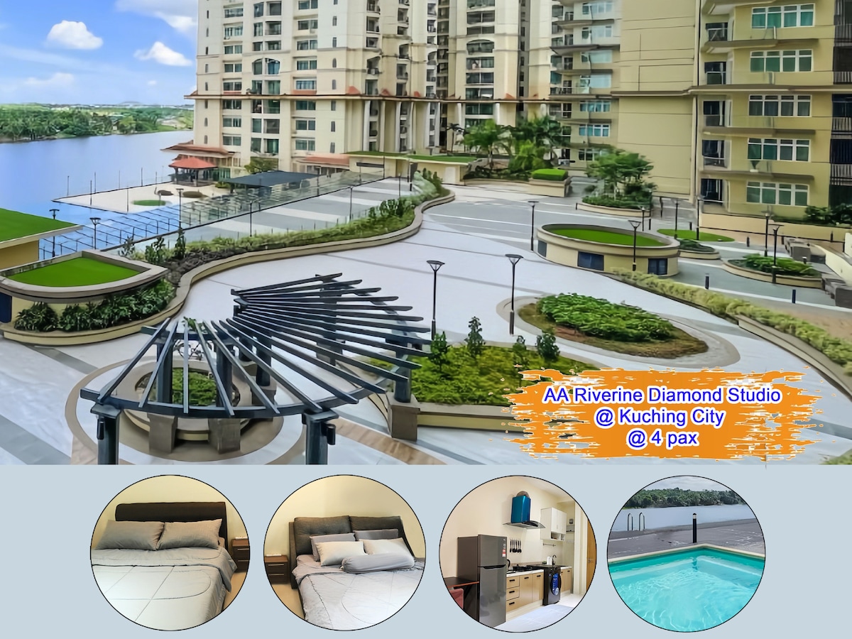 An outdoor area is featured, showcasing landscaped pathways, open spaces, and seating arrangements. The building architecture presents a modern design, with water views visible in the background, indicating a serene environment. Lush greenery complements the surrounding areas.