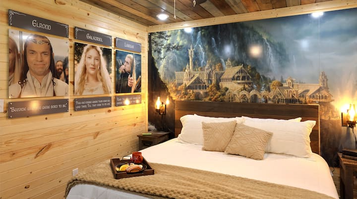 Odmorite se u eleganciji! S muralom elvenske arhitekture koji oduzima dah, udobnim krevetom i elegantnim uređenjem, ova spavaća soba nudi miran odmor u planinama Smoky Mountains.