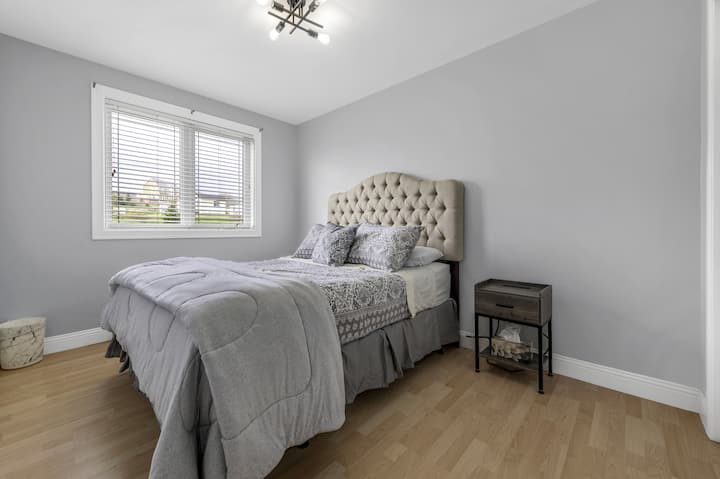 Queen bed with closet space & side tables with charging ports for electronics
