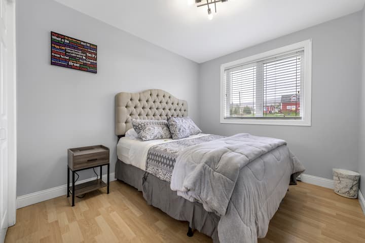 Queen bedroom with a closet & two side tables with charging ports for electronics