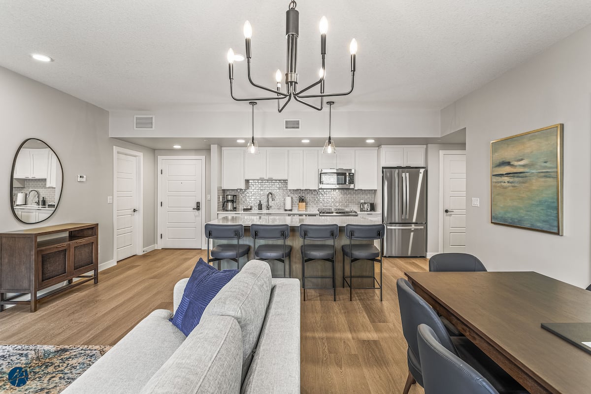 Open-concept living room at The Owl's Nest Canmore-area condo with electric fireplace