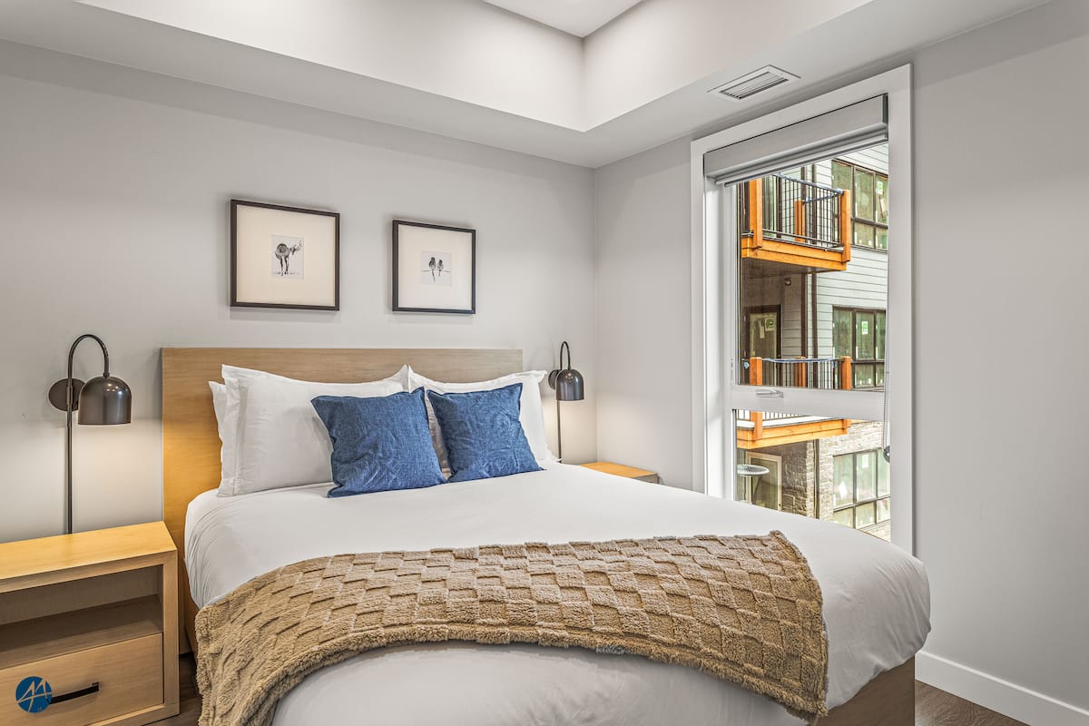 The Owl's Nest Canmore-area condo — Second bedroom with queen bed