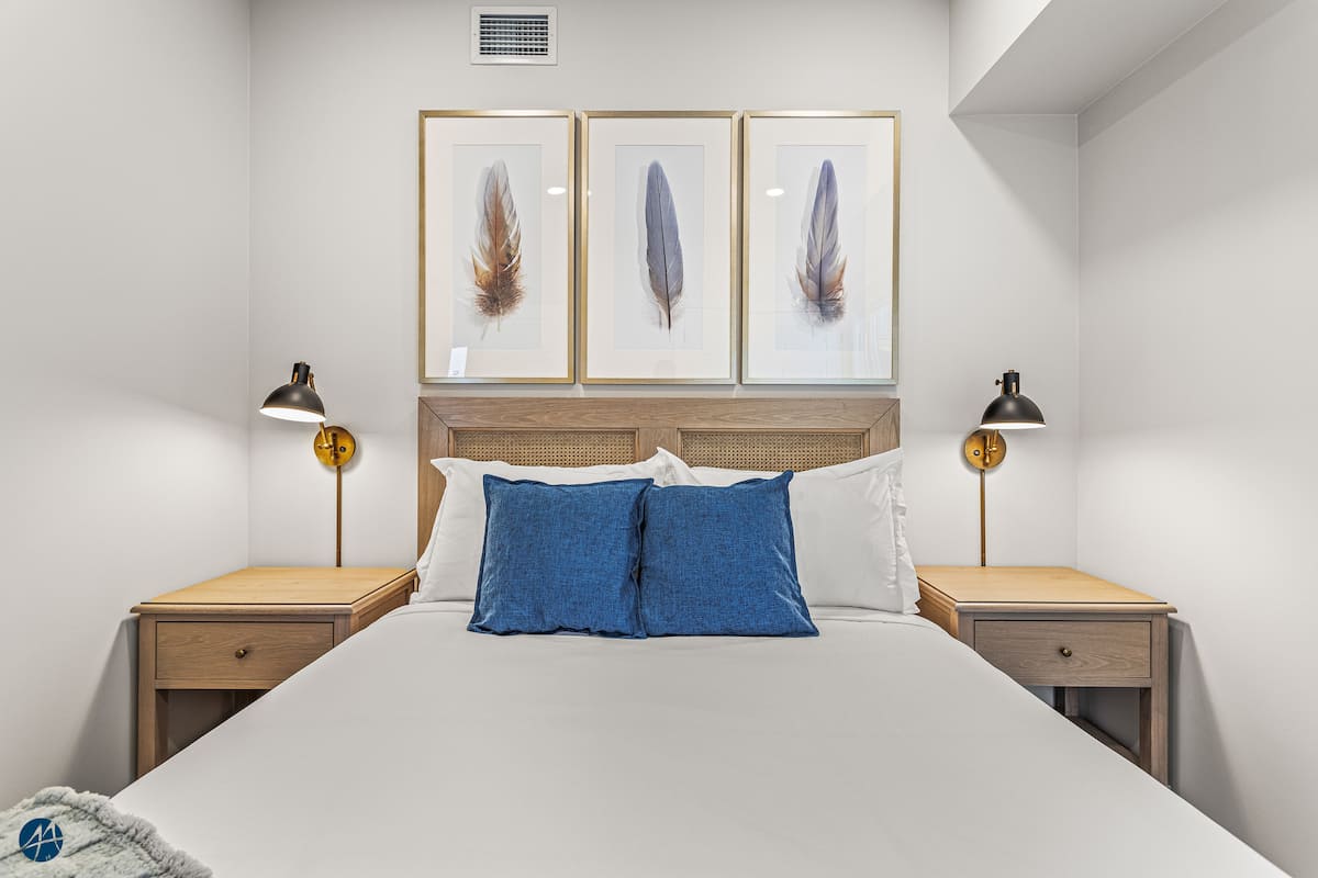 The Owl's Nest Canmore-area condo — Third bedroom with queen bed