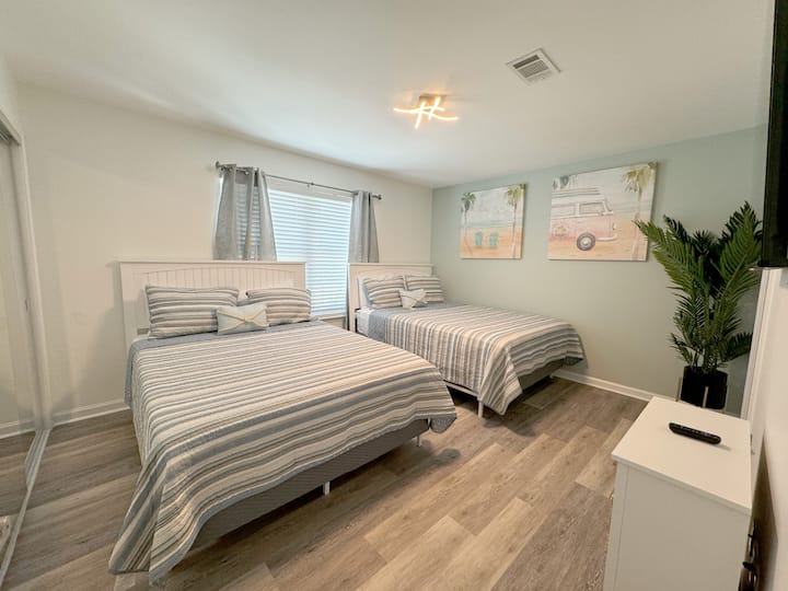 Two queen beds can accommodate up to 4 adults comfortably in this room. Bedroom has a TV and en-suite bathroom.