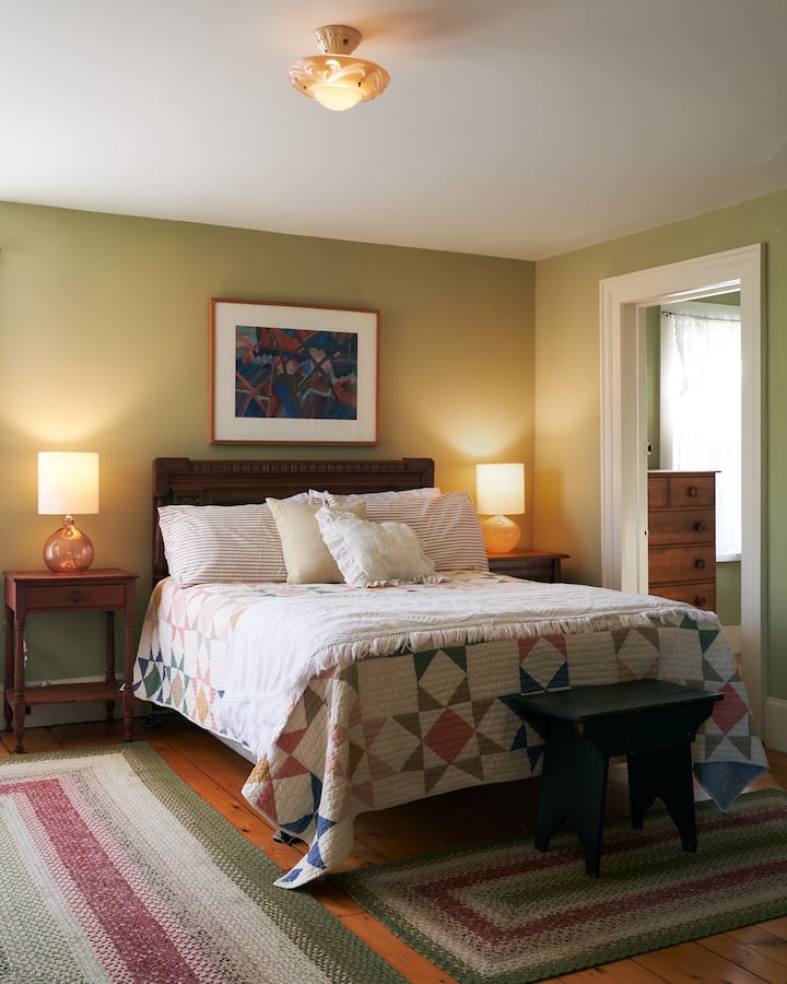 Master Bedroom - with king size bed, two arm chairs, standing vanity, and walk-in closet which is often used with pack-n-play as an en-suite nursery. Beautiful eastern morning light.