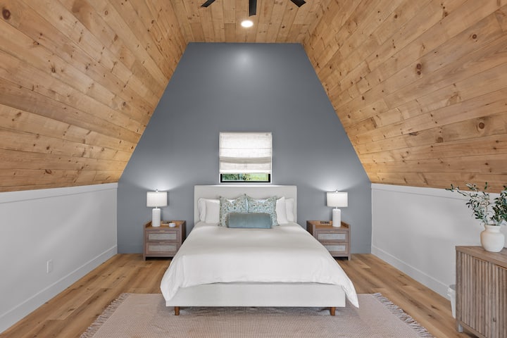 Extremely comfortable queen size bed with plenty of pillows, two night stands with lamps on each.