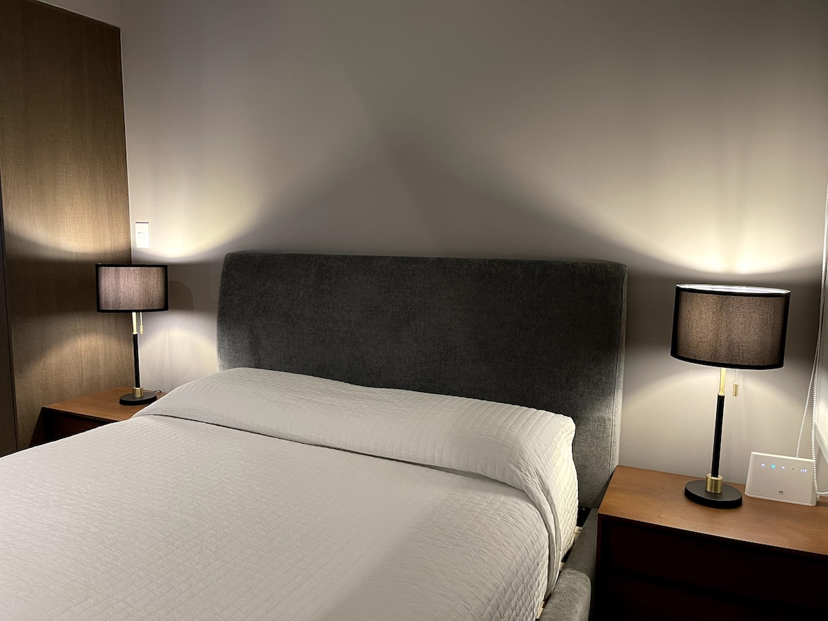 Cama tamaño matrimonial con cobijas disponibles en el closet.