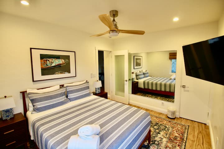 Master bedroom includes queen bed, smart TV, walk-in closet, and full length mirror. Equipped with blackout shades to ensure a restful night’s sleep at any hour.