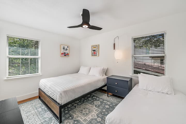 This bedroom has a cozy queen bed and a twin bed, adorned by pieces by local “monster” artist Gerardo Rodríguez.