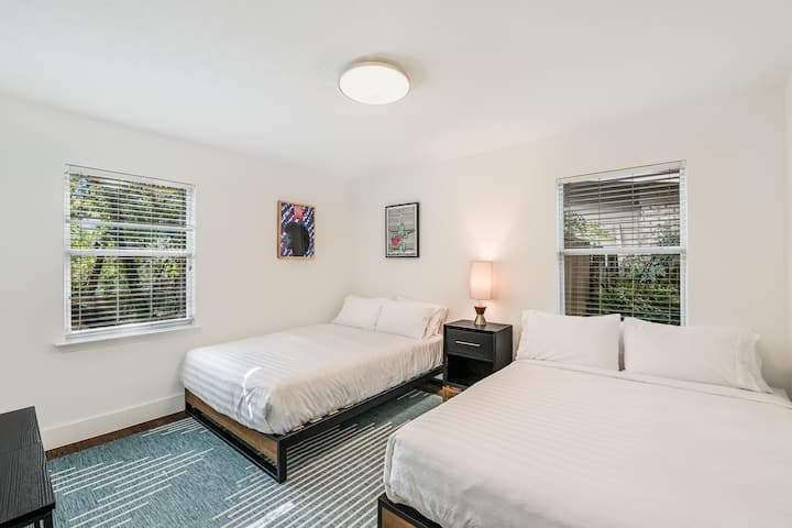 Live-music themed room with 2 queen beds, luxury linens, and local screen prints.