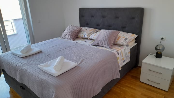 Main bedroom with a king-size bed and private balcony.