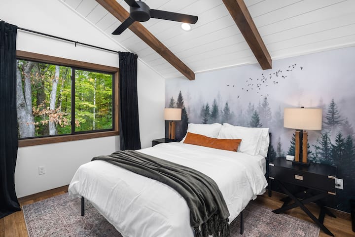 Cozy bedroom with forest views.
