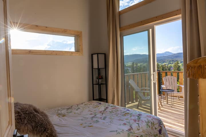 This bedroom has a queen sized bed and private access to the deck. Sunrise and sunset views from bed.