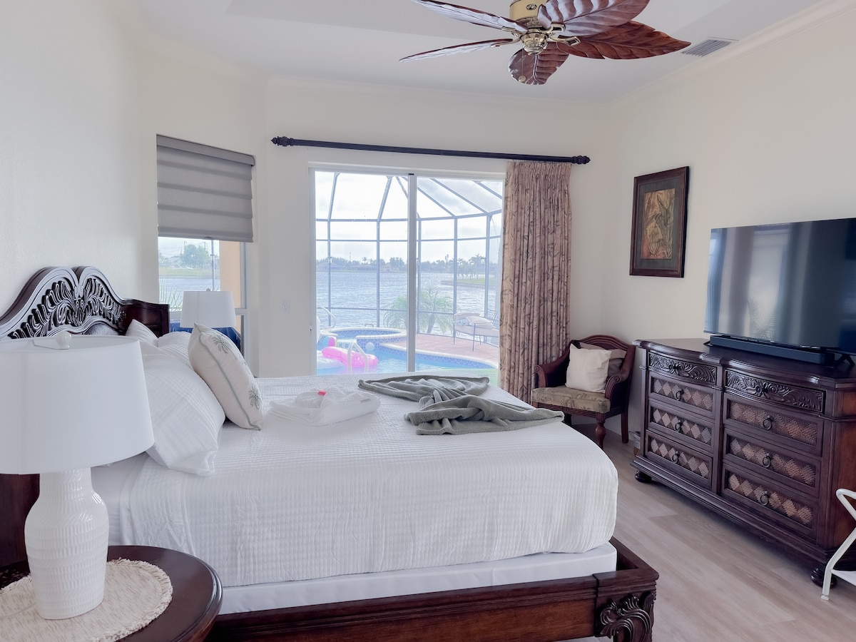 The master bed overlooks the pool and expansive lake views.  Enjoy a 55" TV with soundbar while you relax.