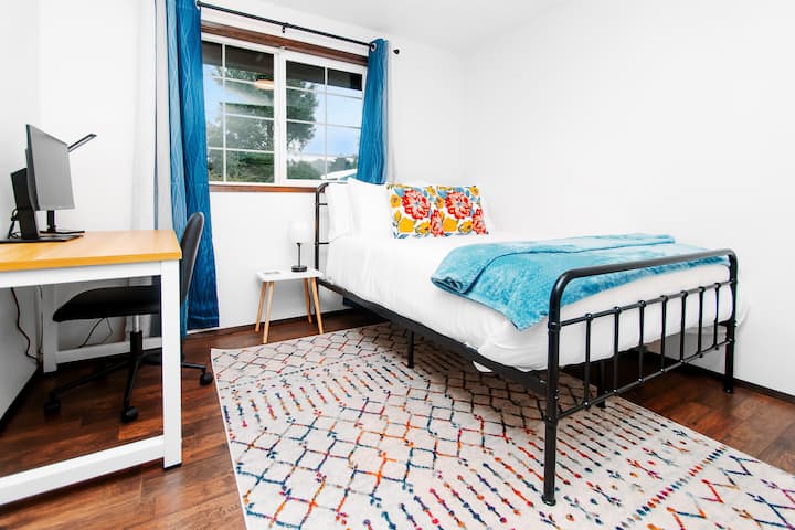 Full sized bed (who wants to sleep on a twin?) and office set up with desk and monitor.  Great for taking a nap when needing a break from remote work .