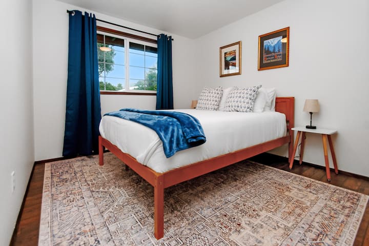 Queen bedroom downstairs with cotton linens and USB charging.