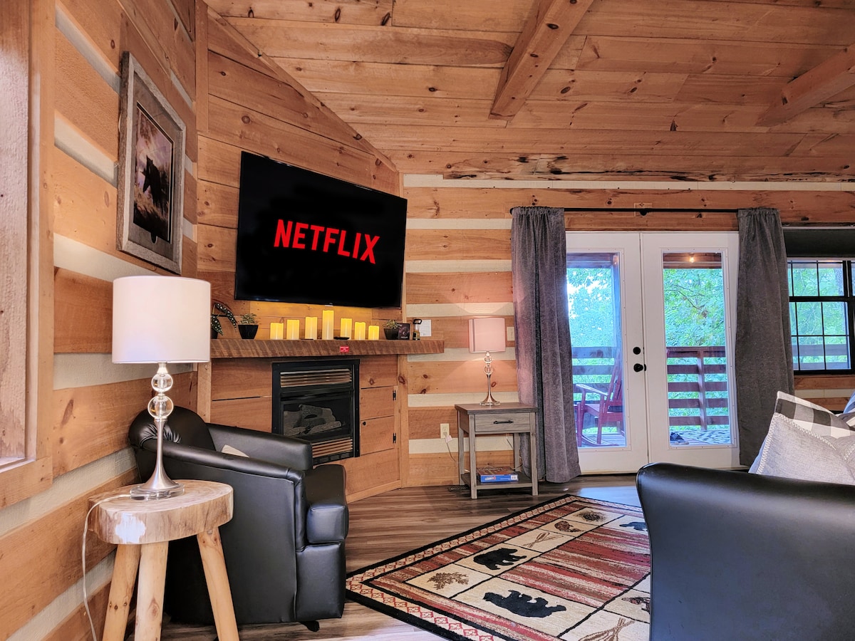 Cuddle up in front of the cozy fireplace at Point of View Cabin and enjoy a romantic movie night on the flat-screen, smart-TV. 