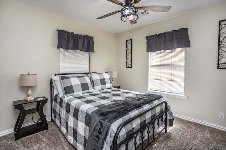 Experience the charm of this bedroom with a full-sized bed, beautiful farmhouse decor, and a smart TV equipped with multiple streaming apps.