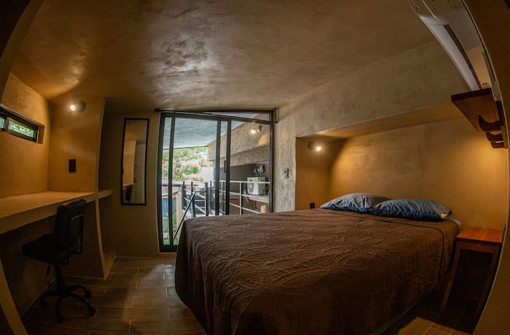 There's a steep flight of stairs to reach the Loft bedroom. The desk area has a sloped (low) ceiling and so it's best for people with a maximum height of 180 centimeters.