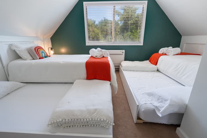Kids bedroom with 2 trundle beds pulled out to accommodate 4 cozy kids
