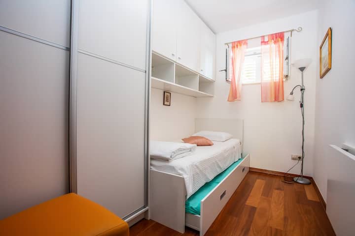Bright and cheerful bedroom with two single beds, ideal for children to relax and enjoy their stay.