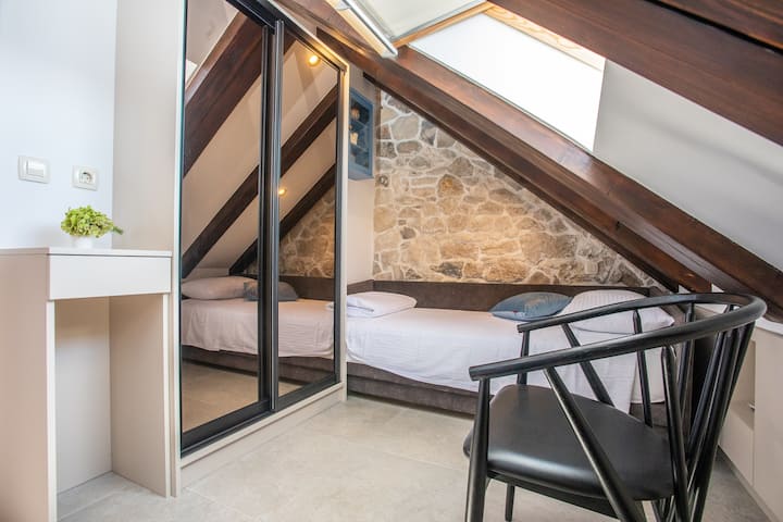 Warm and inviting bedroom with two single beds, perfect for children or friends to rest comfortably.