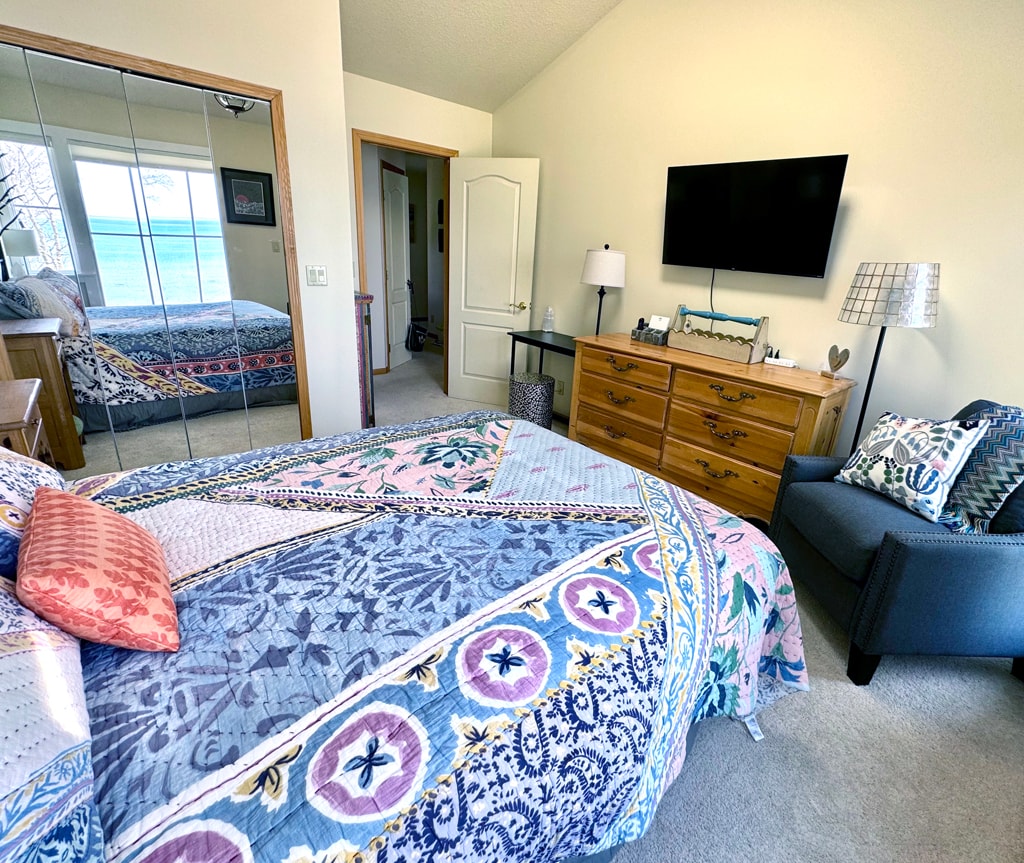 Second guest bedroom with a queen bed, mirrored closet with hangers, iron, ironing board, dresser, small desk and TV equip with ROKU for your personal streaming. The 2nd floor full bath is directly across the hall.
