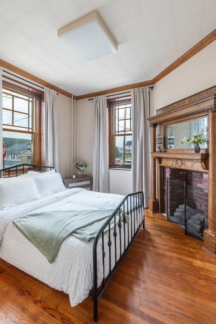 1st Floor Bedroom with first floor bathroom and walk in shower in close proximity.  Decorative fireplace.