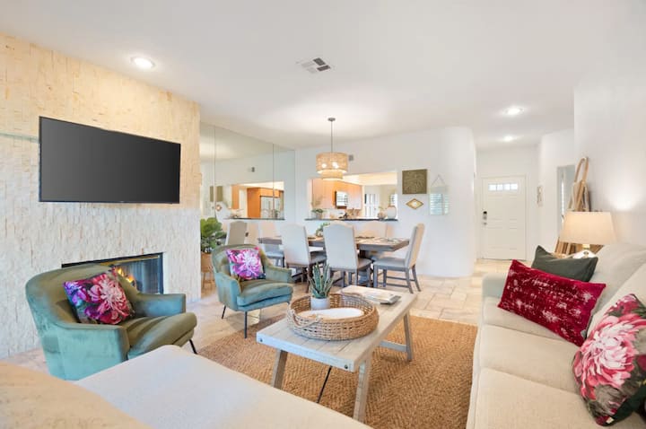 Living Room with oversized, comfortable seating, a smart TV with cable/streaming options, and an indoor gas fireplace.