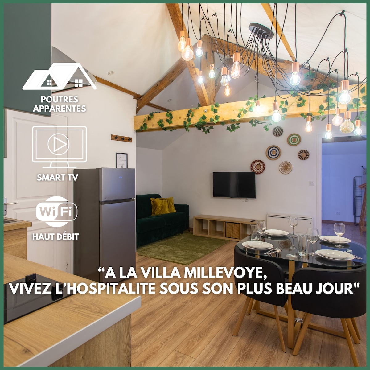 A stylish living area is featured, with exposed beams enhancing the space. A cozy green sofa faces a modern media unit, which includes a Smart TV. A dining table is set for four, with elegant tableware displayed. Warm pendant lights create a welcoming ambiance.