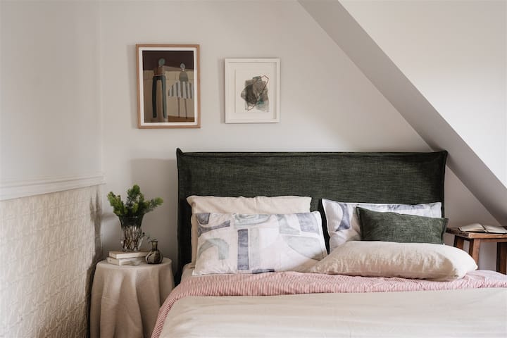 Located on the upper level, Bedroom 2 features a Queen bed, high quality linens and original artworks.
