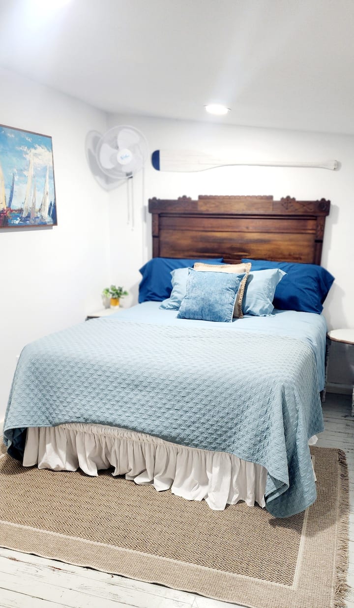 Comfortable queen bed is separated from single bed by curtain.  Night stands with phone charging plug, and a convenient armoire and dresser. Private and light blocking shades and fan.
