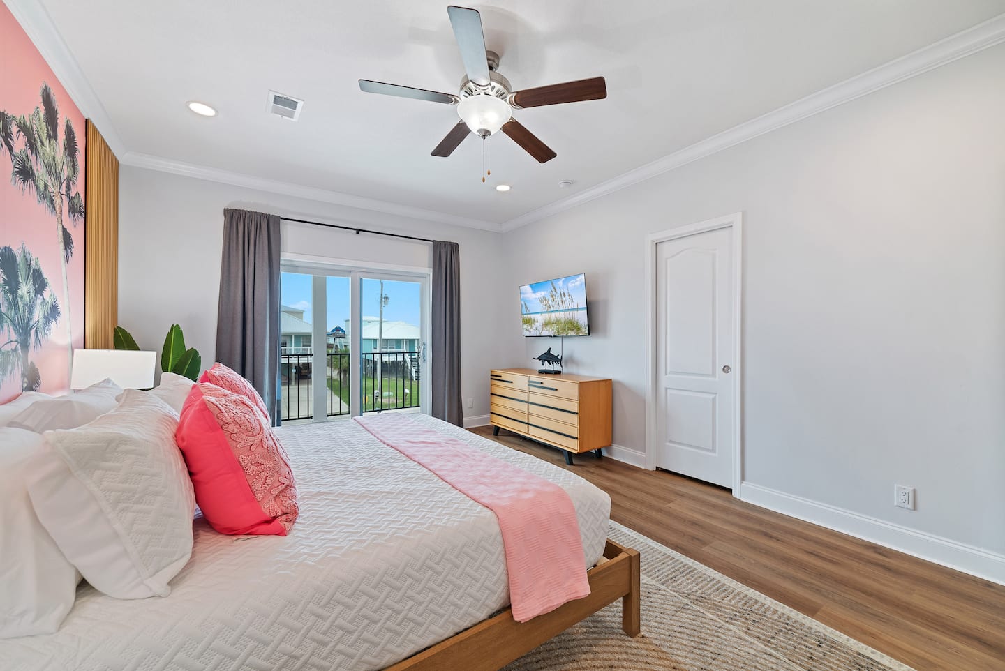 Primary bedroom with Roku TV and balcony