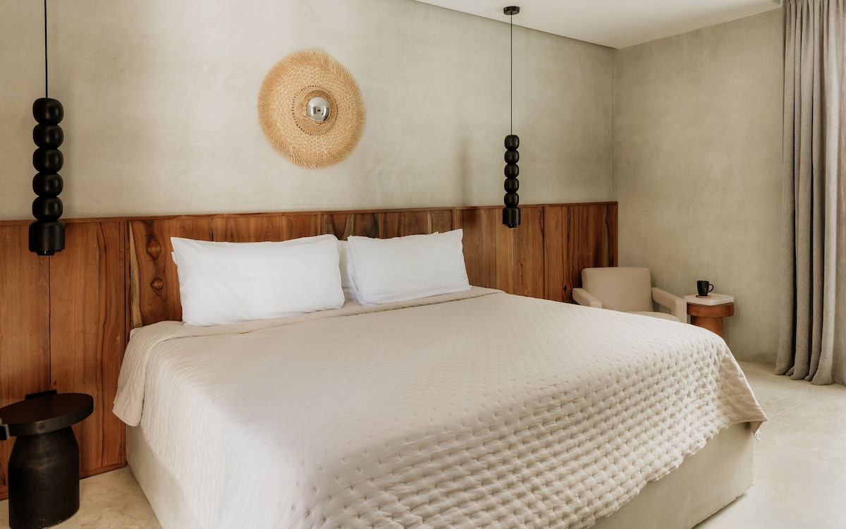 Ground-floor king bedroom with direct access to the pool area, thoughtfully curated with refined details for your comfort and enjoyment.