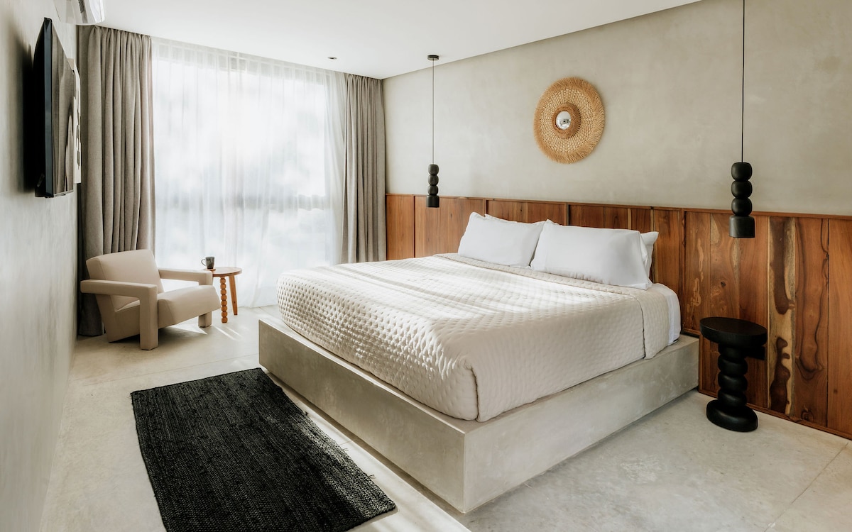 Spacious king bedroom featuring curated interior details and tasteful artwork, creating a refined and calming space for restful nights.