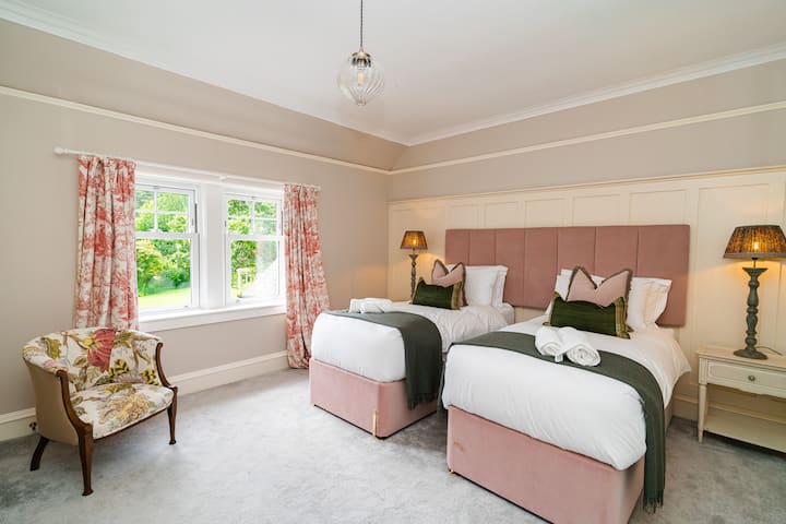 ROOM 3 - It can be set up as a Super-King or Super-Single Twins, with a private shower ensuite with a rainfall shower, and beautiful views of the garden and country hills.