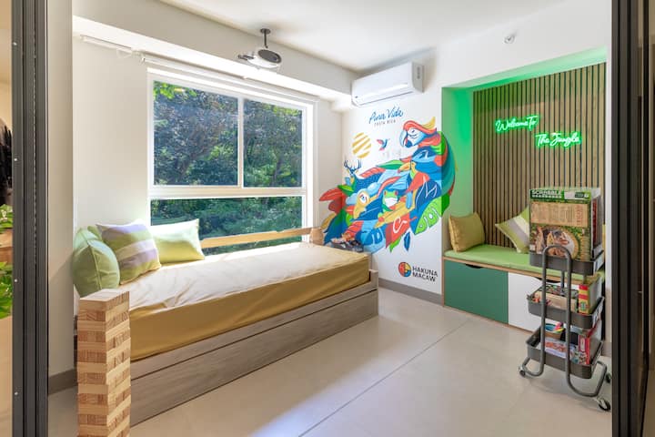 Discover our exclusive glass room with unique design, perfect for intimate moments or enjoy nature. Equipped with two single beds (nest) and two storage drawers just below "Welcome to the Jungle!"