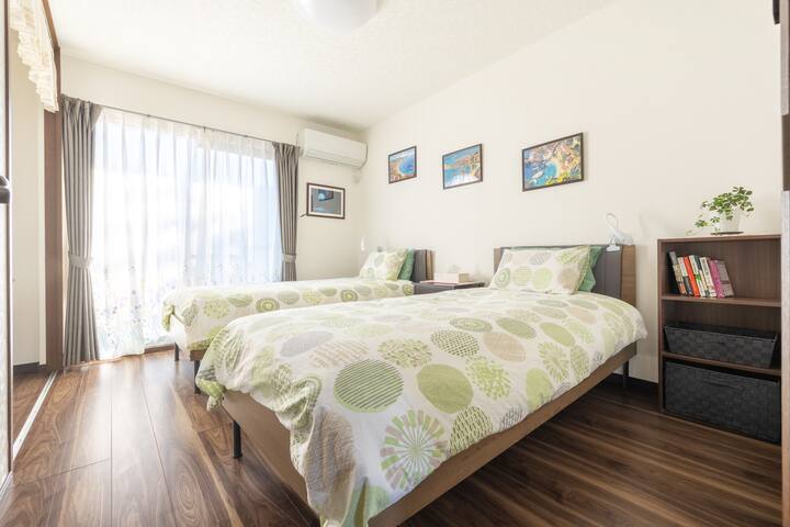A peaceful bedroom surrounded by nature, refreshing your mind and body.
Relax and rejuvenate in a serene bedroom surrounded by nature.