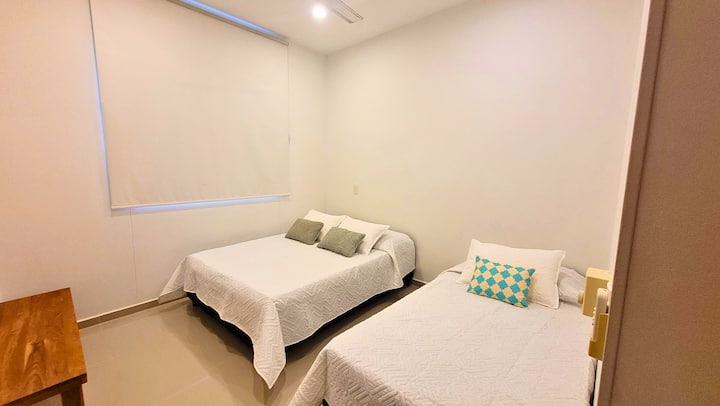 Beautiful room with an ensuite bathroom, 1 double bed and 1 single bed with TV, air conditioning and ceiling fan. It also has blackouts to prevent light from entering while you sleep.