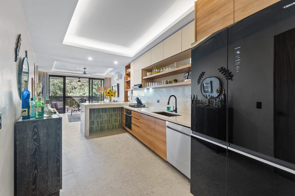 Cook in a proper kitchen with real tools: full appliances, marble countertops, a fridge that handles the week.