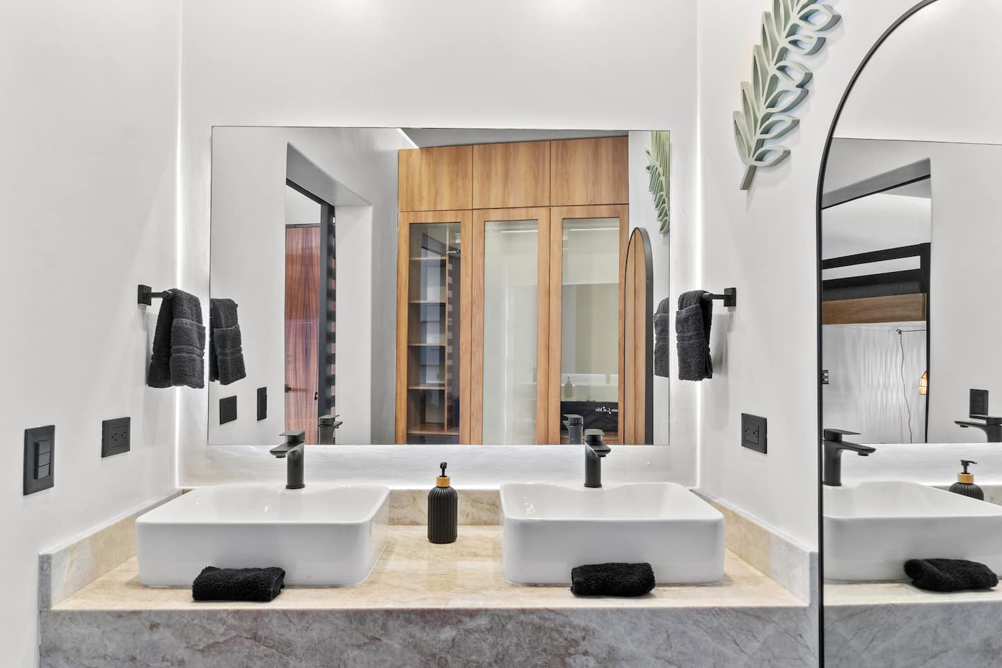 Use the double vanity any time you want: marble countertops, black hardware, no sharing required.