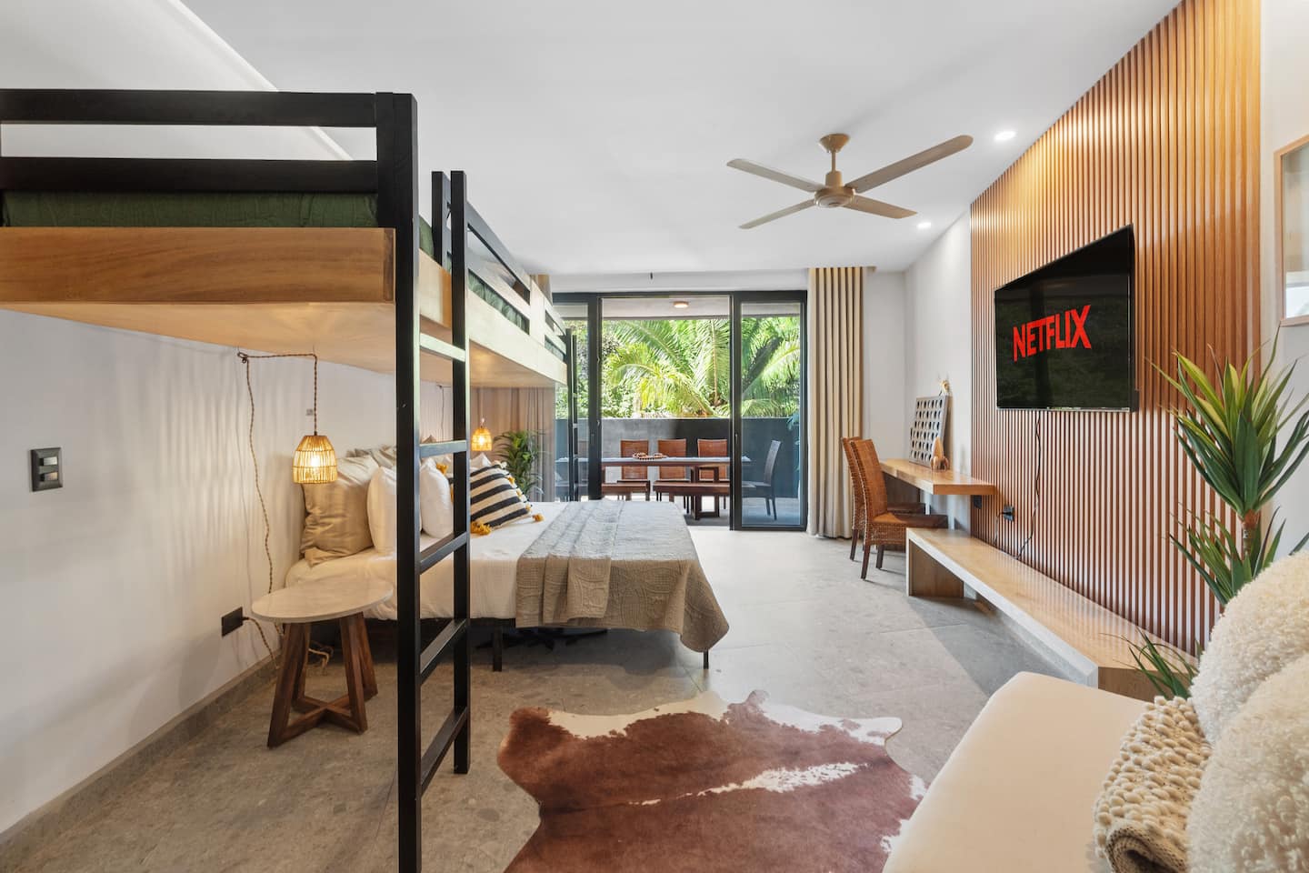 Let the kids have their room: bunk bed, Netflix on the wall, and a balcony just outside.