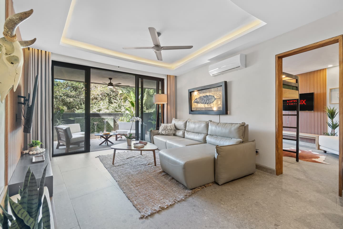 Your living room: AC on, sectional sofa calling, glass doors to the terrace wide open.