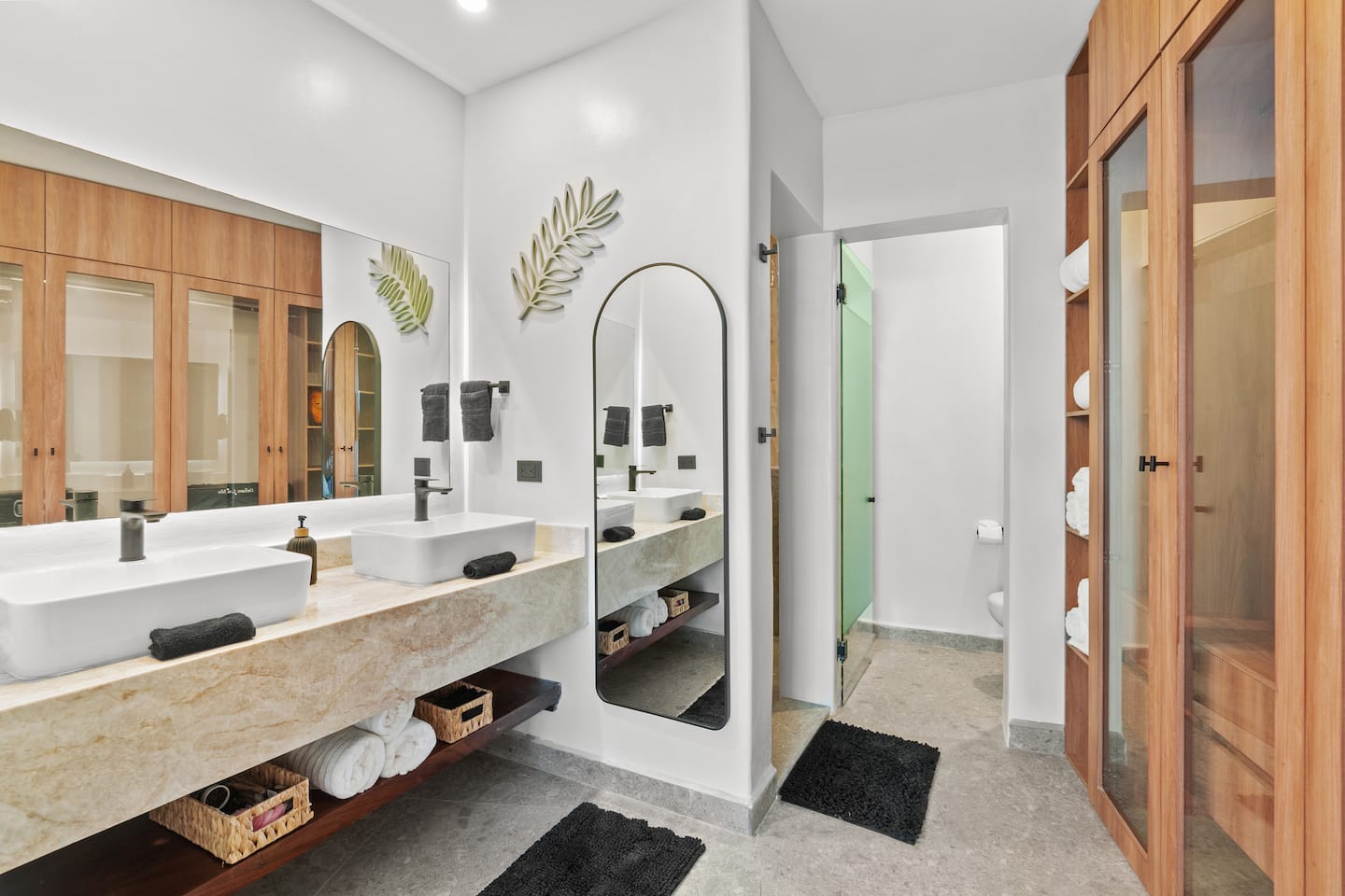 Step into a bathroom that actually feels like a hotel: double sinks, marble, towels already stocked.