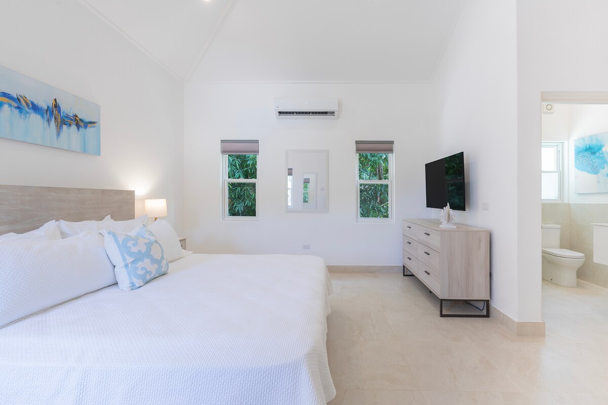 Bedroom 7 within a private cottage with ensuite and garden views, mini fridge, smart TV and a filtered shower head.