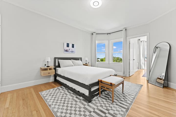 Enjoy the spacious bedroom with a full-size mattress and a pull-out bed underneath for extra sleeping arrangements. This bedroom is connected to the sunroom, which we've converted into an additional sleeping space.